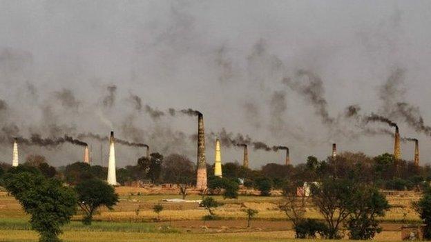 smoke rises from brick kiln chimneys on the outskirts of New Delhi, India. In