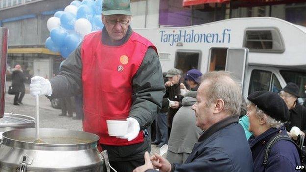 People being given soup at a campaign event in Finland