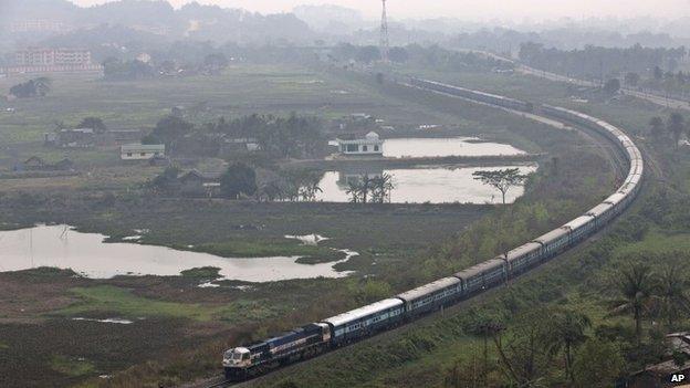 An Indian railways train moves through a track on the outskirts of Gauhati, north-eastern Assam state, India, Thursday, Feb. 26, 2015.