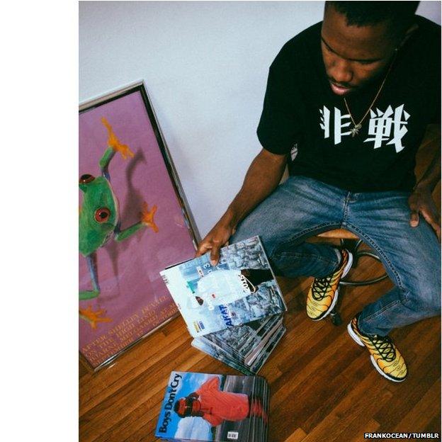 Frank Ocean with piles of magazines