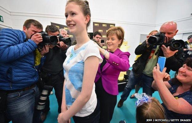 Scotland's First Minister Nicola Sturgeon signs the back of Sam Davidson