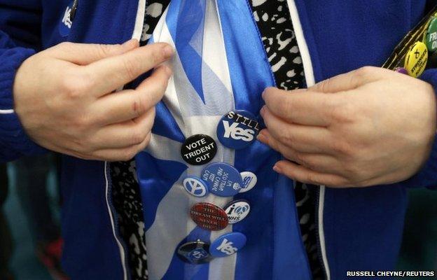 Badges are seen on an SNP supporter