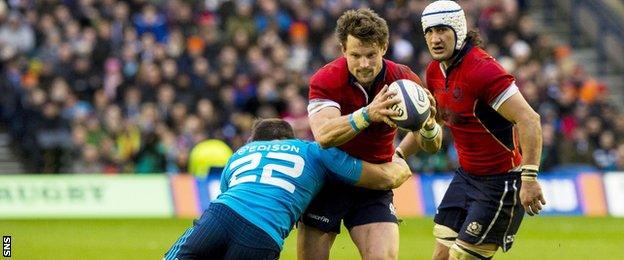 Peter Horne is tackled for Scotland against Italy in the Six Nations