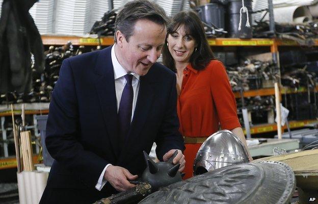 David Cameron and his wife Samantha look at a weapon in a Belfast workshop, during a visit to the set of the TV fantasy drama Game of Thrones