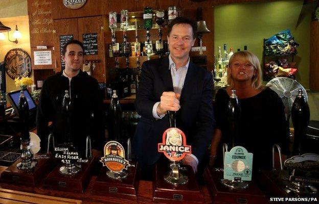 Liberal Democrat leader Nick Clegg pulls a pint with Phillip Hayton and Janice Wright of Platform One pub in Romiley