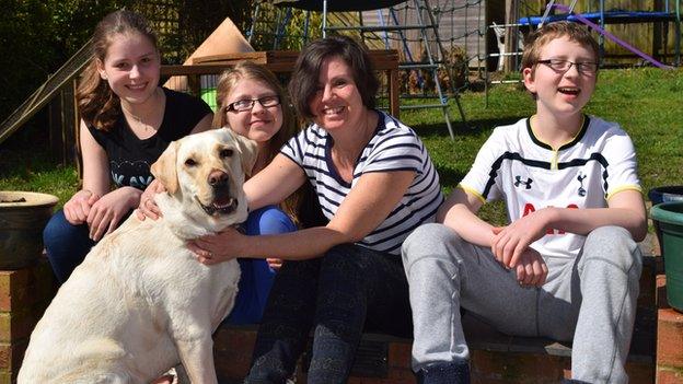 Tabitha, 15, Poppy, 14, mother Rebecca, and Dylan, 12, with Tanni the hearing dog