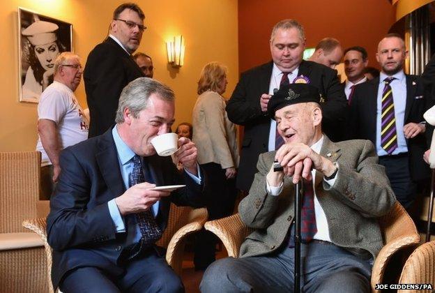 Nigel Farage has a cup of tea with World War II veteran William Curtis after giving a speech on defence at Himley Hall, near Dudley