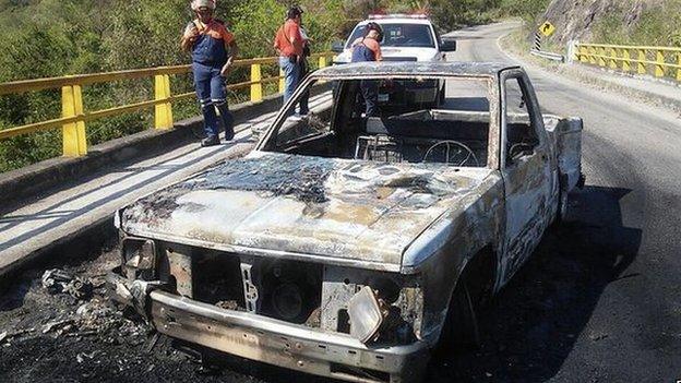 A burnt vehicle after a shooting between Mexican authorities and alleged criminals in Soyatan, Mexico, on 6 April 2015