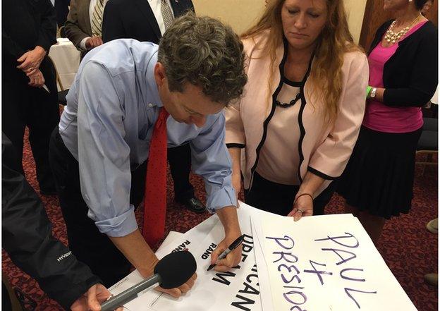 Rand Paul writing on poster