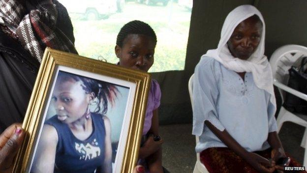 Someone holding a photo of a woman who died in the Garissa University College attack