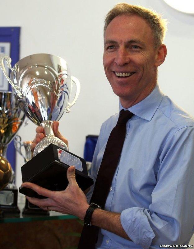 Scottish Labour leader Jim Murphy holds a trophy as he arrives at the Aberdeen Foyer