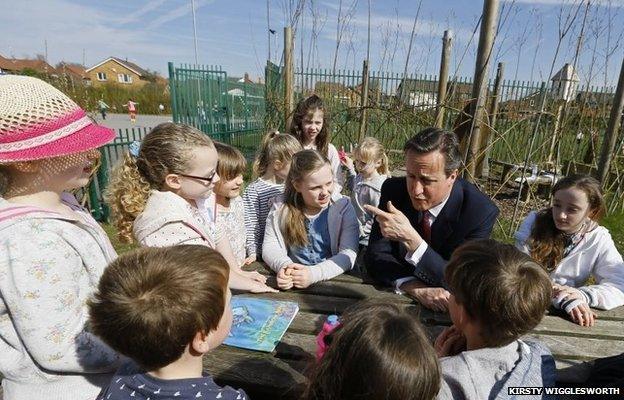 Britain's Prime Minister David Cameron talks to children during a visit to Sacred Heart RC primary school in Westhoughton