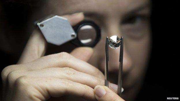 A jeweller scrutinises a diamond