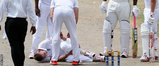 Stuart Broad clutches his ankle