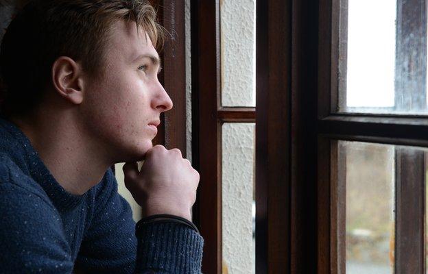 A man looking out of the window