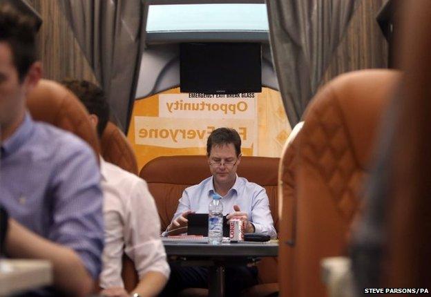 Leader of the Liberal Democrats Nick Clegg works on the battle bus after a visit to Bodmin