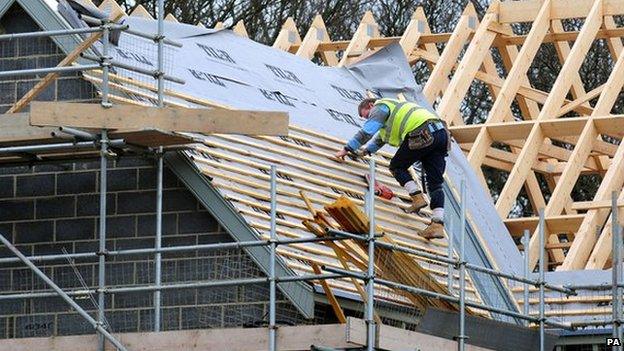 An apprentice roofer at work