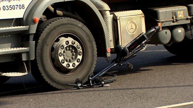 The cycle trapped under the wheels of the lorry