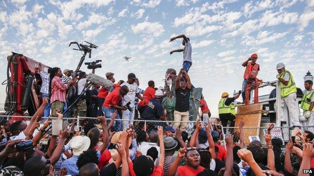 The statue of one of apartheid's architects Cecil John Rhodes is removed as thousands cheer from the University of Cape Town