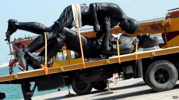 French Algerian born artist Adel Abdessemed's five-meter high (16.4-feet) Coup de Tête sculpture is seen loaded onto a lorry after being removed from Doha's corniche on 30 October, 2013. Qatar has removed the Zinedine Zidane headbutt statue less than a month after it went on display following an outcry by conservatives, who slammed the art work as anti-Islam idolisation. Doha News website said the statue will now join Abdessemed's collection that is on display in the Arab Museum of Modern Art, citing QMA chief marketing officer Kimberly French