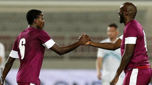 Qatar players celebrate after beating Slovenia