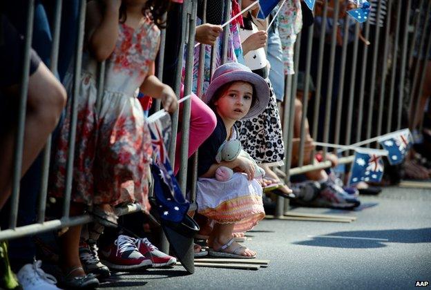 Children watch the Anzac Day parade in Brisbane, Friday, 25 April 2014.