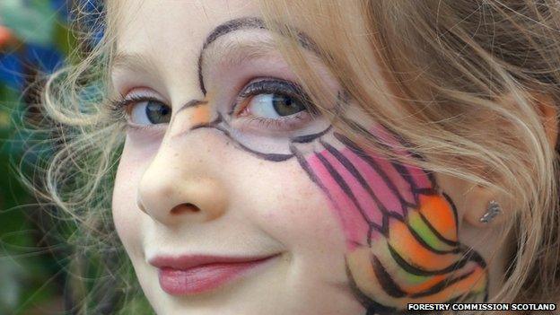 Girl with Pictish symbol-inspired face paints