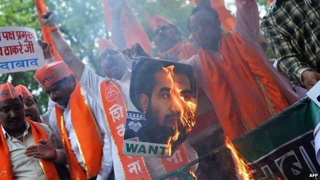 Protesters burn a poster bearing the image of Zaki-ur-Rehman Lakhvi in New Delhi