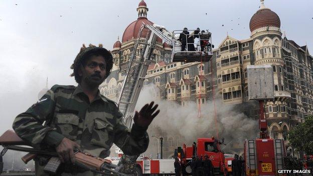 An Indian soldier prevents people from approaching the The Taj Mahal Hotel after a rescue operation in Mumbai on November 29, 2008