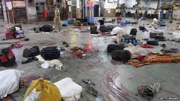 An Indian policeman checks the shooting site of Chattrapati Shivaji Railway terminus on 26 November, 2008 in Mumbai