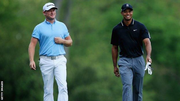 Jamie Donaldson of Wales and Tiger Woods of the United States walk up the fifth hole