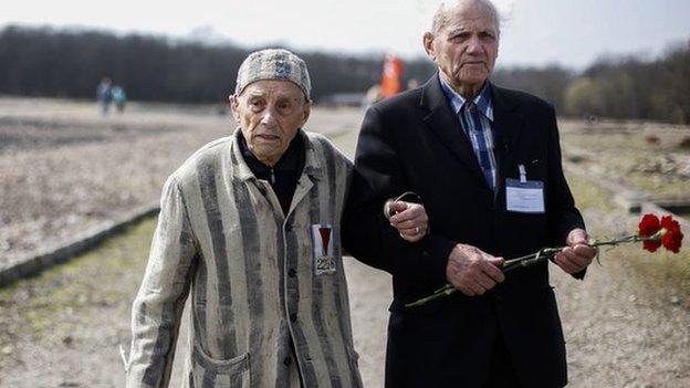 Buchenwald survivors Alexander Bytschok, left and Andrej Moiseenko walk through the former Nazi concentration camp Buchenwald on 11 April, 2015