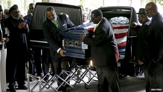 The casket of Walter Scott is removed from a hearse for his funeral at the Ministries Christian Centre on 11 April, 2015