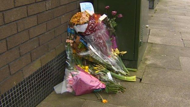 Flowers remained at the scene on Sunday