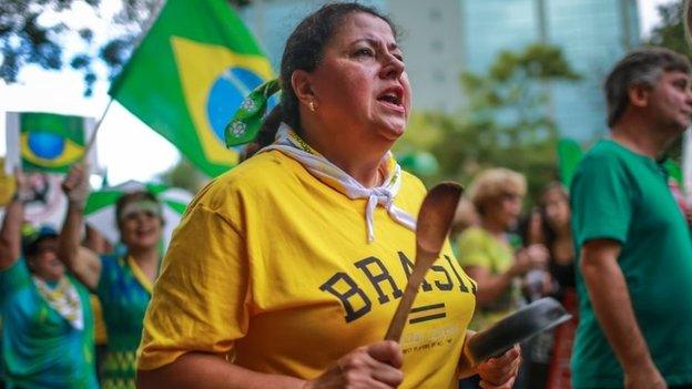 A woman bangs a pan during a protest against Brazilian President Dilma Rousseff in Porto Alegre, Brazil on 12 April 2015.