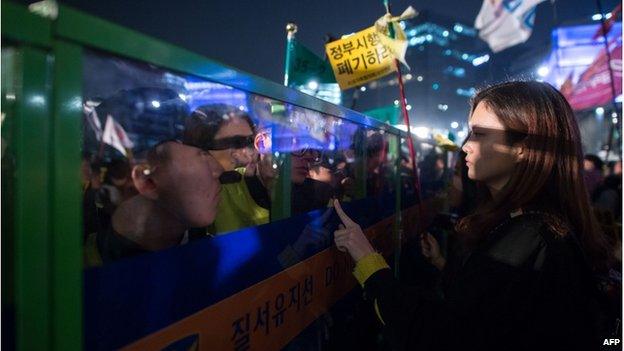 Protesters and relatives of victims of the Sewol ferry disaster standoff with police as they attempt to march to the presidential Blue House in Seoul on 11 April 2015