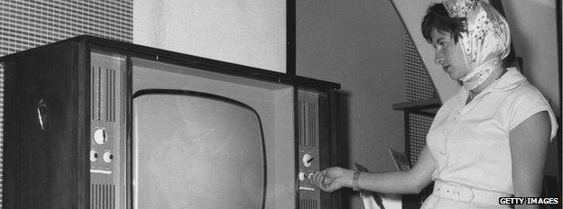 woman looks at TV, 1960