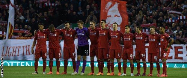 Liverpool players observe a minute's silence