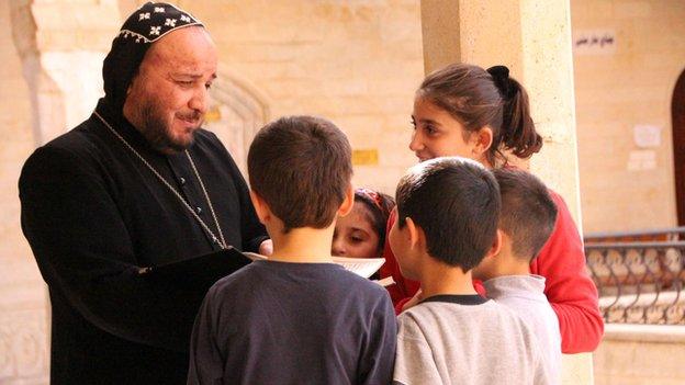 Father Yusuf, a monk in Mar Mattai with refugee children