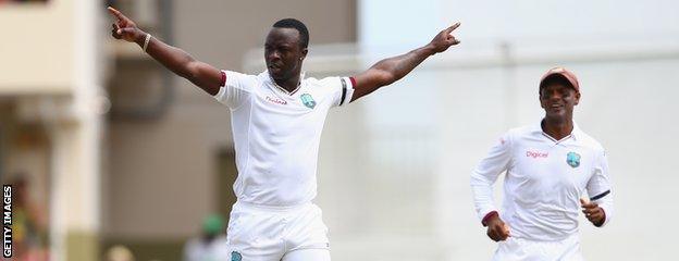 Kemar Roach celebrates a wicket