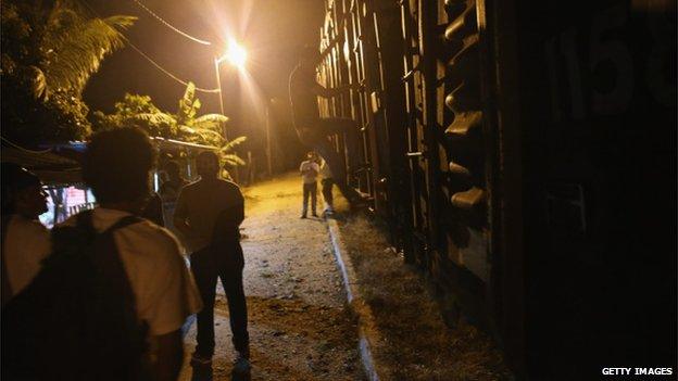 Migrants seek passage on freight train in Mexico