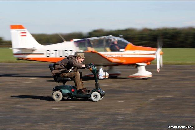 Colin Furze races his mobility scooter against a plane