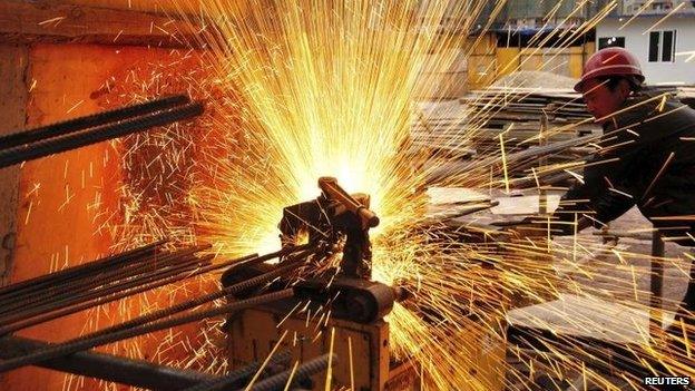 A worker welds at a construction site in China