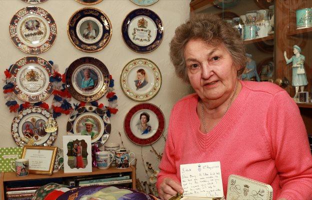 Mary Relph holds a piece of royal wedding cake