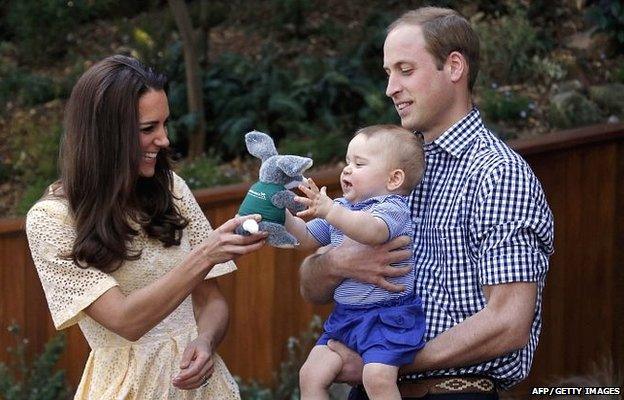 Prince William, (R) his wife Catherine, the Duchess of Cambridge (L) and their son Prince George during a visit to Sydney"s Taronga Zoo