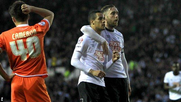 Tom Ince celebrates scoring with Richard Keogh