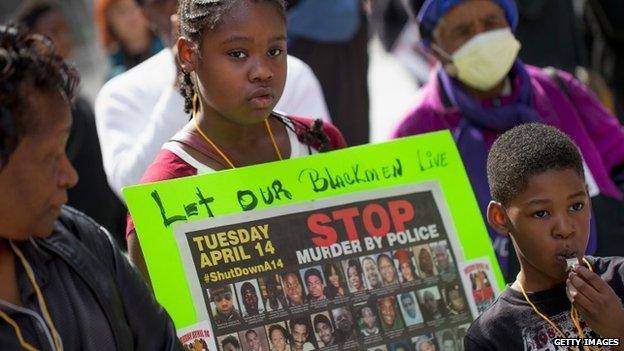 Demonstrators gather in Daley Plaza to draw attention to the shooting of unarmed men by police on April 14, 2015 in Chicago, Illinois