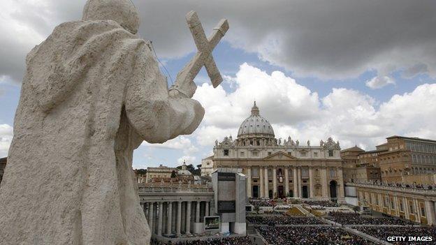 Faithful stand in front St Peter"s basilica during the Easter Holy Mass on 8 April 2012 at St Peter"s square at The Vatican