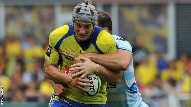 Clermont's Jonathan Davies is tackled by Wales centre partner Jamie Roberts of Racing Metro