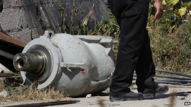 A firefighter stands next to the radiation head in Hueypoxtla, Mexico on 5 December